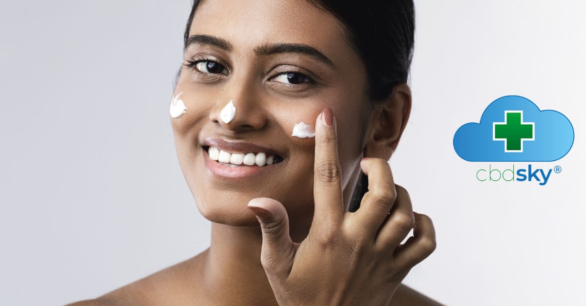 Ethnic woman applying cdn facial cream to nose and cheeks