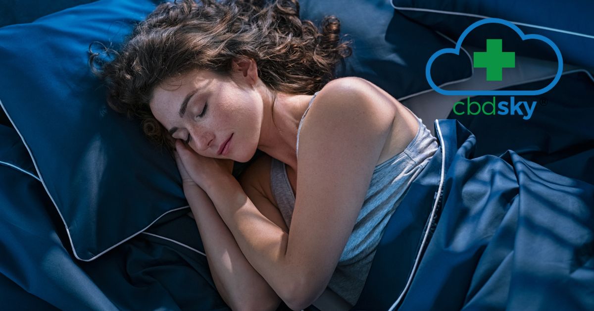 A young woman sleeping peacefully in a blue bed thanks to cbd.
