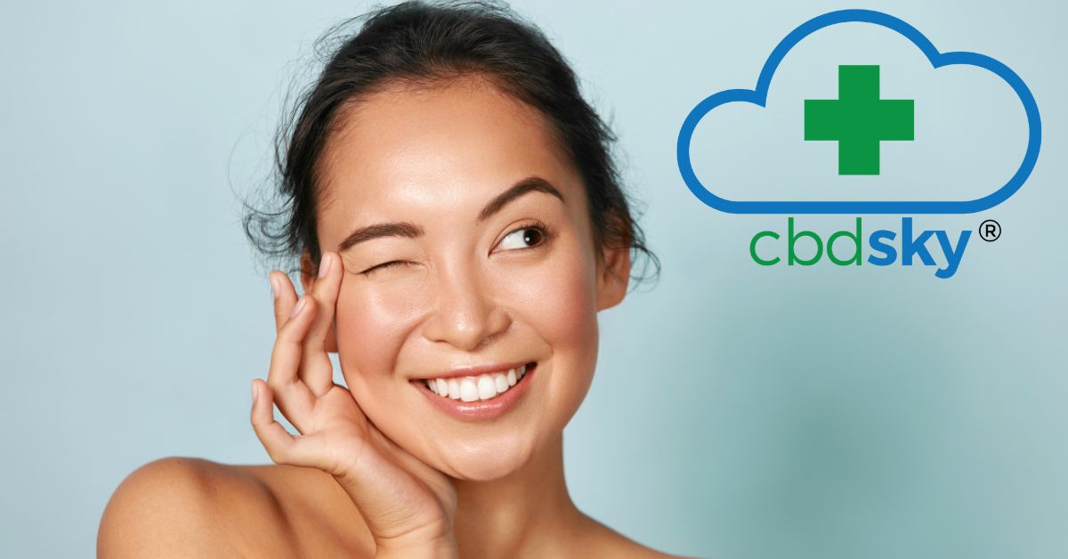 woman winking towards cbdsky logo after applying cbd facial cream