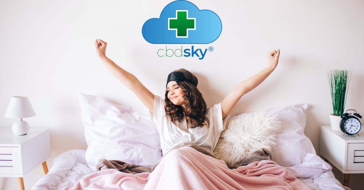 Woman with outstrecthed arms in bed with pink sheets waking up great from cbd 300mg gummies